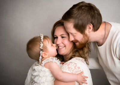 Lekfull barnfotografering flicka med mamma och pappa i Kristianstad Skåne