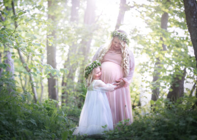 Utomhus Gravidfotografering på våren mamma och dotter i lånad klänning och krans i Kristianstad nära Sölvesborg och Hässleholm