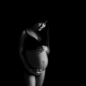 Hudnära Gravidfotografering Jenny med bar mage och mycket skuggor i studio i Kristianstad nära Hässleholm
